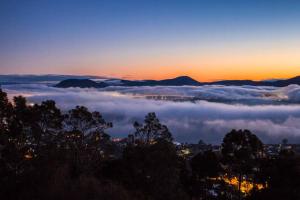 a view of a sea of clouds at sunset at Sandy Bay Townhouse in Sandy Bay +5 photos