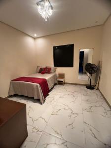 a bedroom with a bed and a flat screen tv at Casa Diamantina in Ibicoara +28 photos