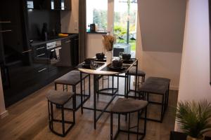 a kitchen with a table and stools in a room at MODERNHOUSE KO26 in Koblenz