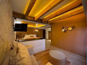 a bedroom with a bed and a couch and a table at Hotel Boutique Casa Laja in San Miguel de Allende