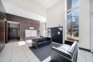 a lobby with black leather furniture in a building at Beautiful Dt 3 Bed 2Bath Apat Free Parking & Pool in Vancouver