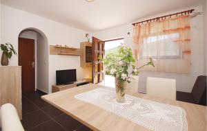 a living room with a table and a vase of flowers at Apartment Kneze With Sea View I in Pupnat
