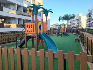 a playground with a slide on a green field at Mar de ensueños in Florianópolis