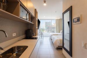 a bathroom with a sink and a bed in a room at Aparta suite Playa Bello Horizonte Santa Marta in Santa Marta +34 photos