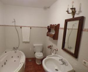 a bathroom with a tub and a toilet and a sink at La Posada de Pedrazales in Pedrazales