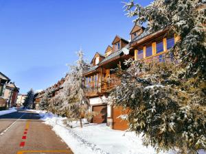 a snow covered street in front of a building at CASA ABETOS Elite in Sierra Nevada