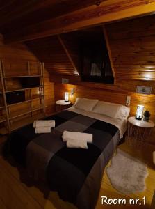 a bedroom with a large bed with towels on it at CASA ABETOS Elite in Sierra Nevada