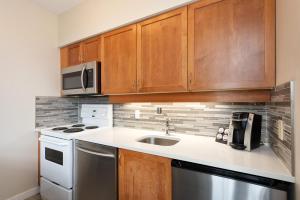 a kitchen with a sink and a microwave at Alpenglow Lodge Junior Penthouse by MVA in Whistler