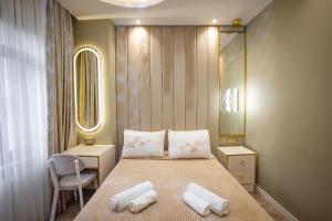 a bedroom with a bed with two towels on it at Hotel Flash in Istanbul