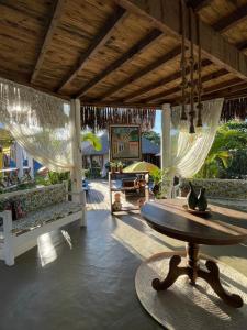 a living room with a table and a patio at Pousada Nascer do Sol in Marau