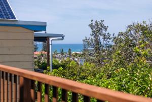 a balcony of a house with the ocean in the background at Sunset House - Oceanstays in Yamba