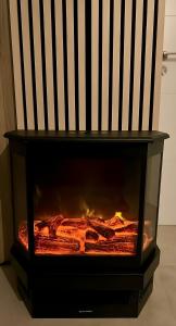 a fireplace with a fire inside of it at Casa Rural las Rosas de Benaojan in Benaoján