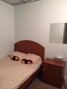 a bedroom with a bed with two pillows on it at Manhattan Bowery Lodge in New York