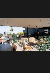 a group of chairs and tables on a patio at Move 517 in João Pessoa