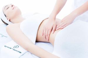a woman laying on a bed with her body in a massage at Art Deco Property in Bromley in London