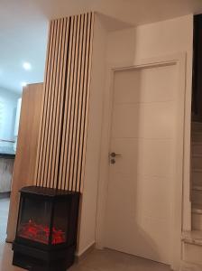 a room with a fire place next to a door at Casa Rural las Rosas de Benaojan in Benaoján