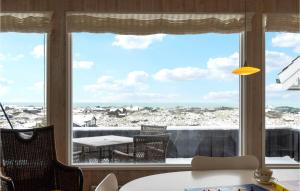 a room with a large window with a view of the ocean at Awesome Home In Saltum With Kitchen in Saltum