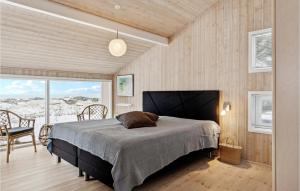 a bedroom with a bed and a table and chairs at Awesome Home In Saltum With Kitchen in Saltum