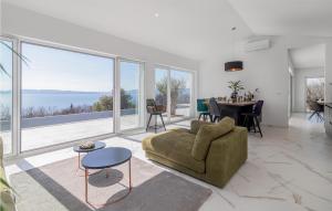 a living room with a couch and a table at Villa Green Wave in Kostrena