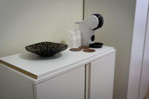 a white table with a lamp and a bowl and a lamp at DeltaRooms in Salerno