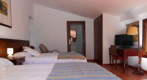 A bed or beds in a room at El Sequer Casa Rural