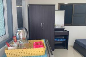 a table in a room with a desk and a cabinet at Na Nont Place in Bangkok