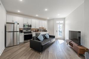 a living room with a couch and a kitchen at Tourist Home of Richmond - Church Hill North Apt01 in Richmond
