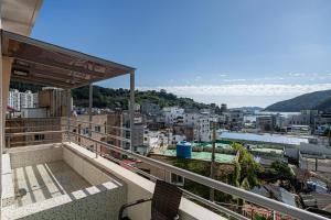 a balcony with a view of a city at Geoje Hound Hotel & Spa in Geoje 