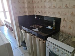 una cocina con estufa y encimera en Apartamento Centro Guarapari- ES, en Guarapari 10 fotos más
