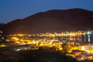 a view of a city at night with a mountain at Katerina Lefkada in Vasiliki