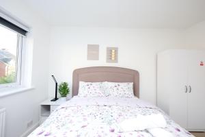 a white bedroom with a bed and a window at Love Deluxe Queen Bedroom Manchester in Middleton