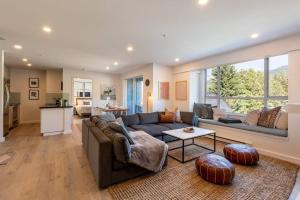 a living room with a couch and a table at Location with Views - 2BDR Penthouse Whistler Village in Whistler