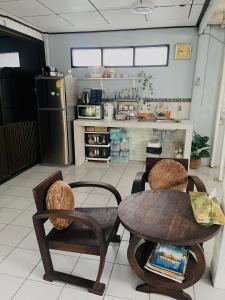 a kitchen with a table and chairs and a refrigerator at บ้านคุณยายอยุธยา in Phra Nakhon Si Ayutthaya +32 photos