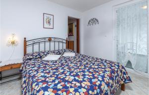 a bedroom with a bed with a colorful comforter at Lovely Apartment In Barbariga With Wifi in Barbariga