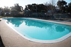 a large swimming pool with blue water at Roseneath Holiday Park in Meerlieu