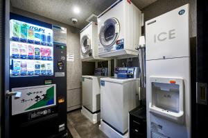a gas station with a machine and a tv at hotel MONday KYOTO MARUTAMACHI in Kyoto +84 photos
