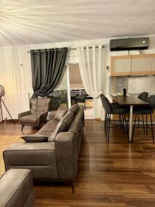 a living room with a couch and a table at LUXE COASTAL RETREAT Apartment in Alexandroupoli