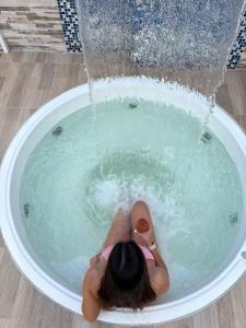 a woman in a bath tub with a fountain at Dadison Plaza Hotel in Piedecuesta +31 photos