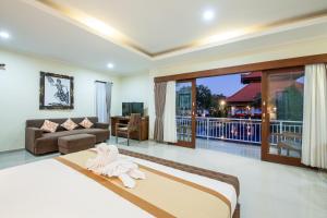 a bedroom with a bed and a living room at Beach Front Hotel Danau Tamblingan St Sanur Bali in Sanur +58 photos