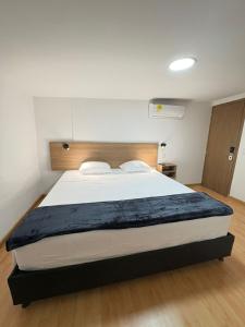 a bedroom with a large bed in a room at Dadison Plaza Hotel in Piedecuesta