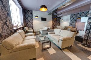 a large living room with couches and a table at Hotel Skilandhouse in Bukovel