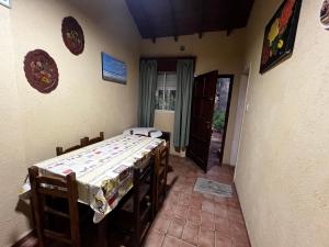 a dining room with a table and a room with a window at Chalet zona del bosque in Valeria del Mar