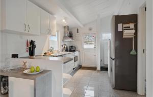 a kitchen with white cabinets and a sink and a counter at Nice Home In Slagelse With Wifi in Slagelse