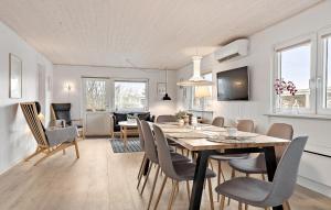 a dining room and living room with a table and chairs at Amazing Home In Haderslev With Wifi in Haderslev