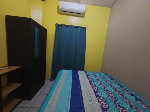 a bedroom with a bed and a tv in it at Hostal La Campana in San Miguel