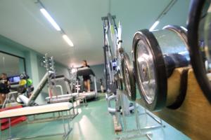a gym with tread machines and people in the background at Green Sporting Club Hotel in Alghero +79 photos