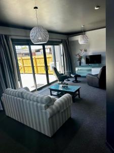 a living room with a couch and a table at Manorburn Apartments Luxury Studio Apartment Central Otago in Ranfurly