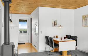 a kitchen with a table and chairs and a stove at Two-Bedroom Apartment In Lemvig in Lemvig