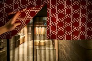 a person is reaching on a metal shelf in a room at MONday Apart Premium KYOTO Station in Kyoto +150 photos