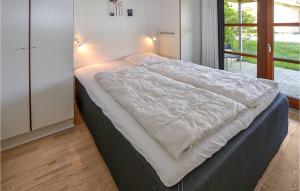 a large white bed in a room with a window at Marina Minde in Egernsund